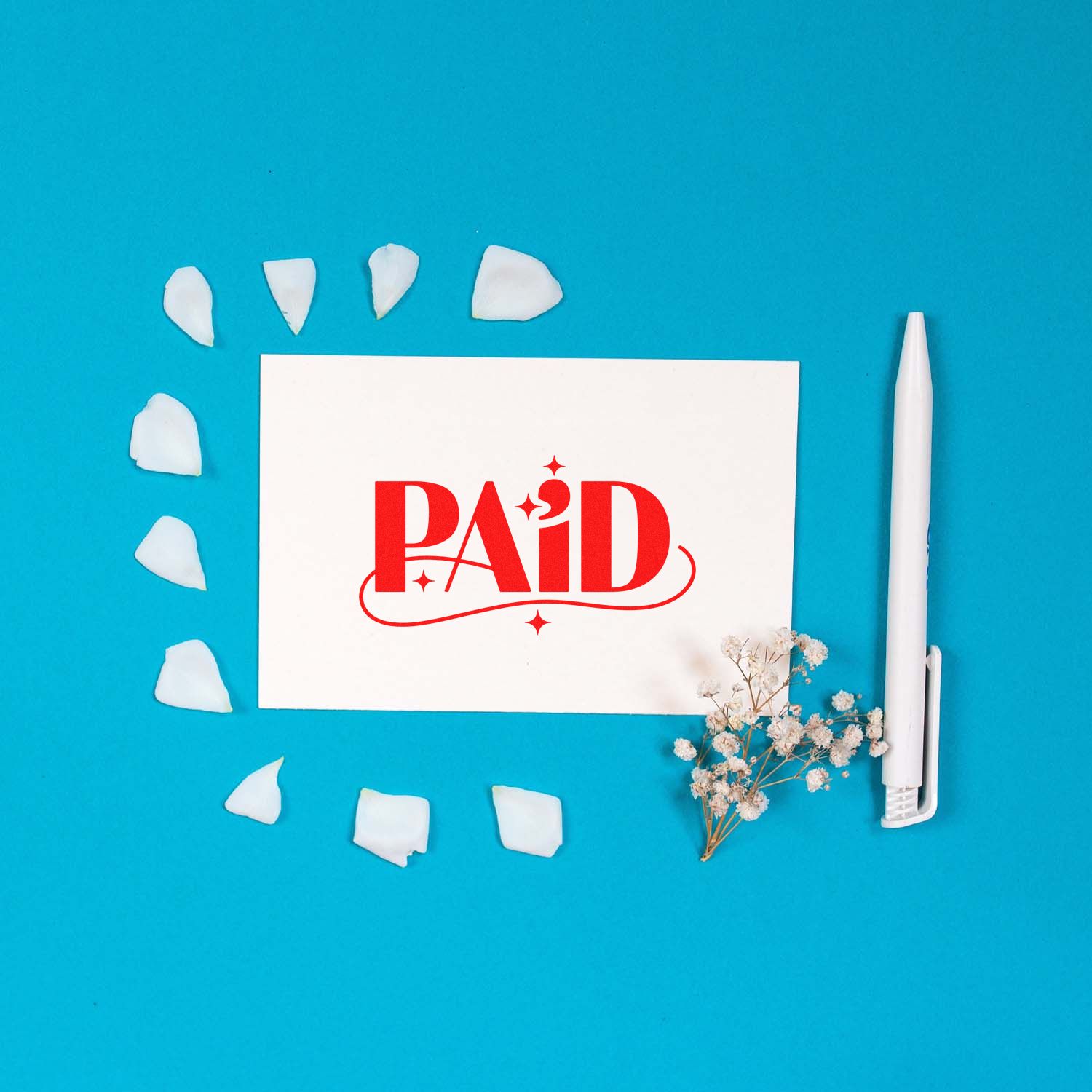 PAID rubber stamp on white card with pen, ideal for invoice processing, bookkeeping, and business accounting.