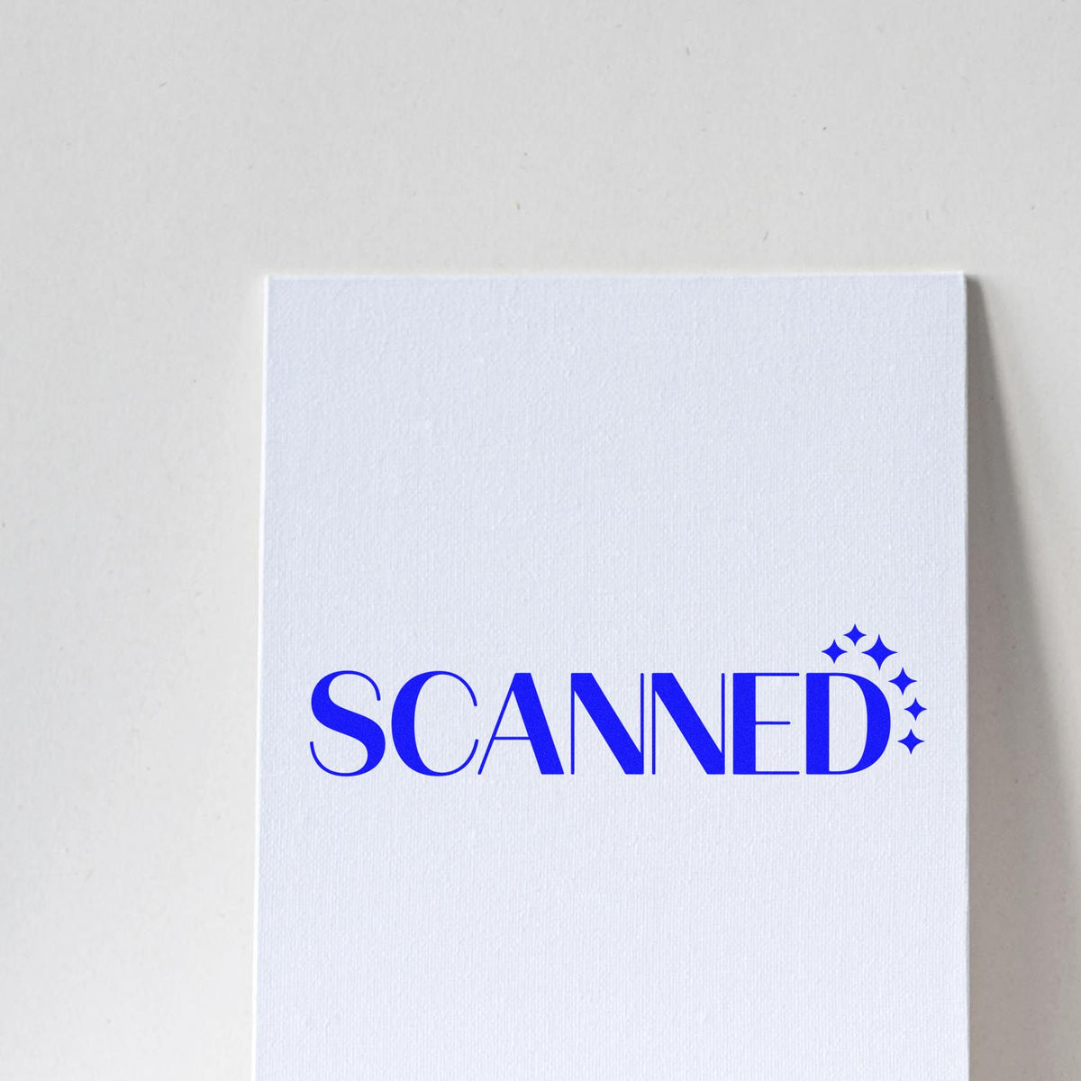 Blue SCANNED rubber stamp design on white card, ideal for document processing, office filing, and paperwork tracking.
