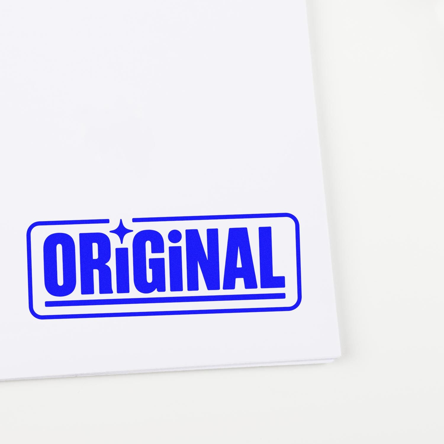 Blue ORIGINAL rubber stamp impression on white paper for product authenticity, branding, and custom packaging.
