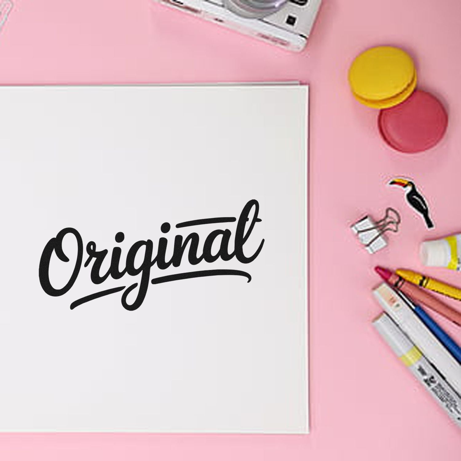 Original script rubber stamp design for stationery and craft projects on a pink desk background.