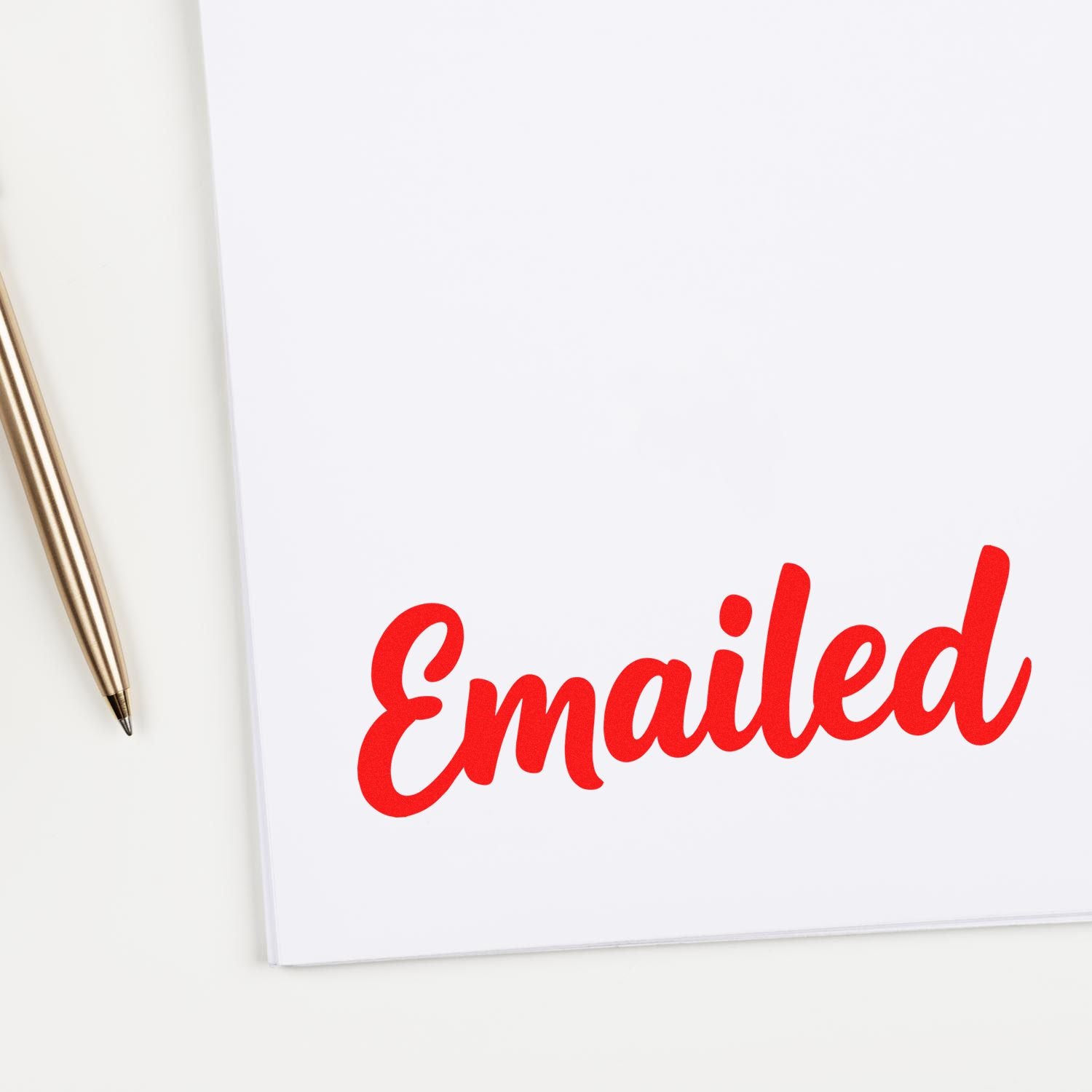 Red Emailed rubber stamp imprint on white paper for office mail tracking and document processing.