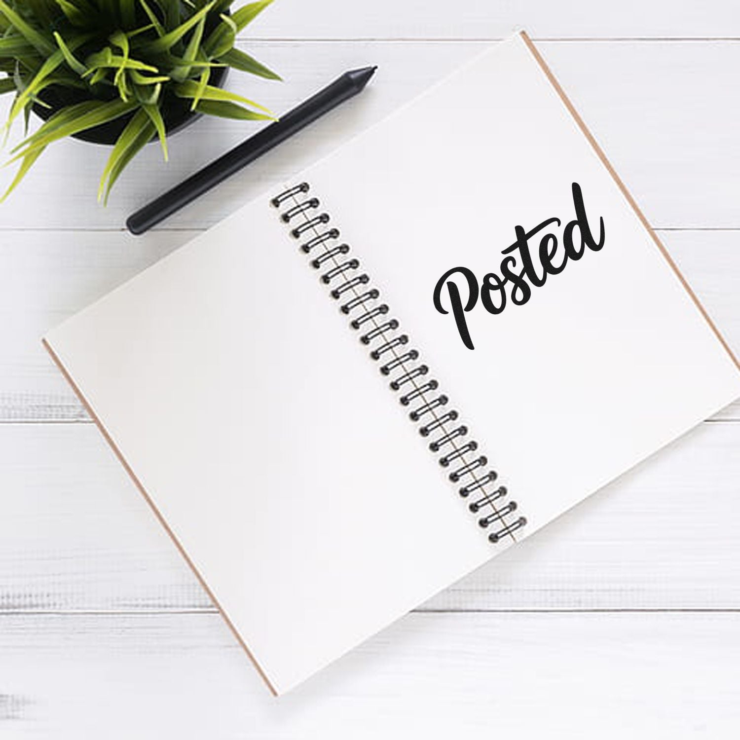 Posted rubber stamp impression on open notebook, ideal for office mail and document processing.