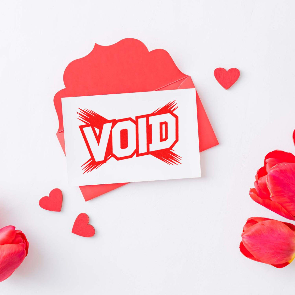 Red VOID rubber stamp impression on white card with hearts and petals, ideal for custom business compliance stamping.