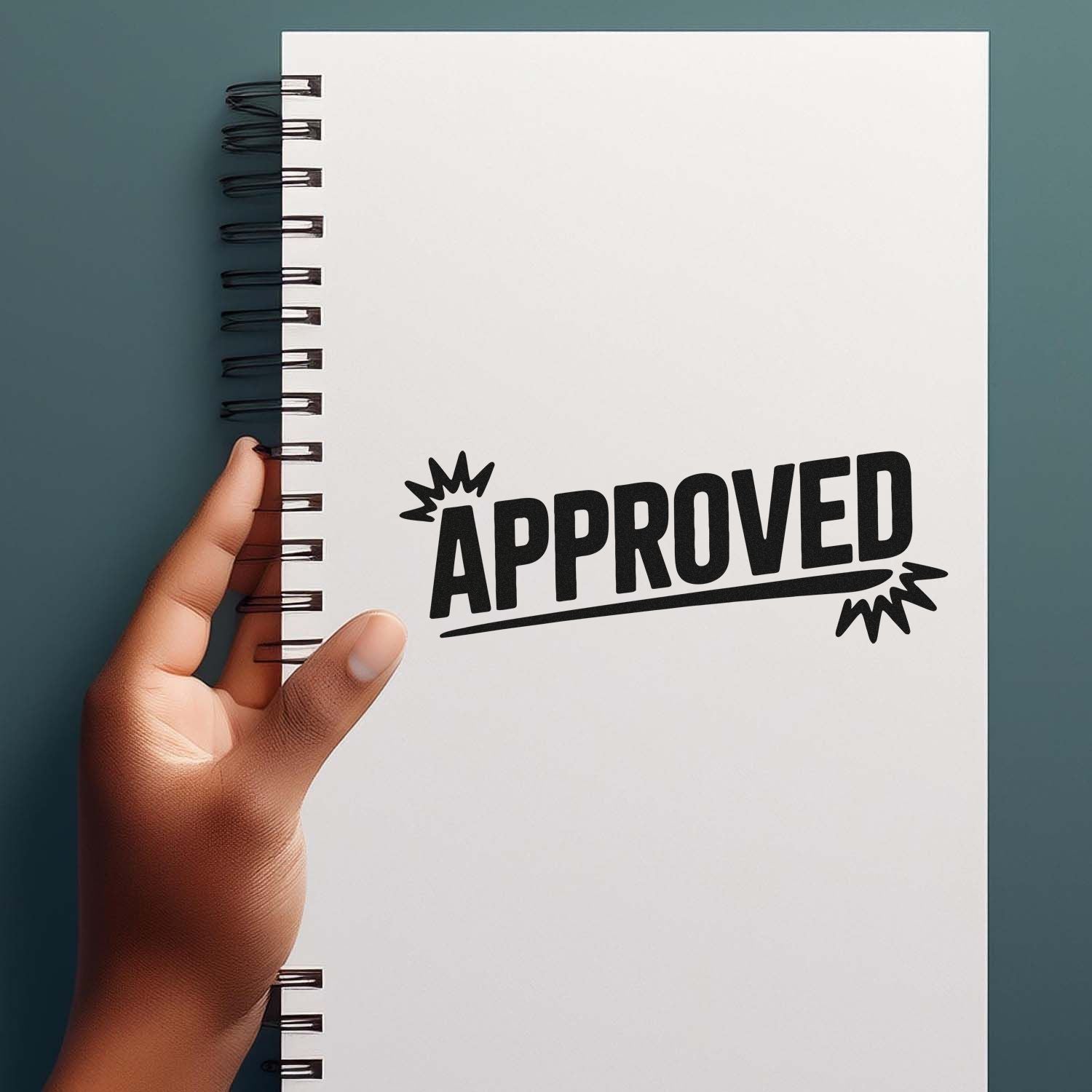 Approved rubber stamp on notebook page held in hand, ideal for office document approval and business use.