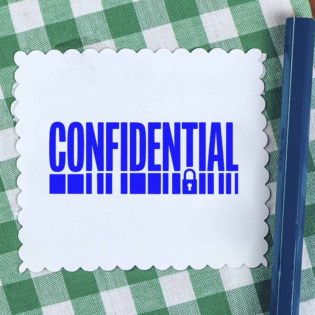 Confidential rubber stamp imprint on paper with pad, ideal for marking sensitive documents and office paperwork.