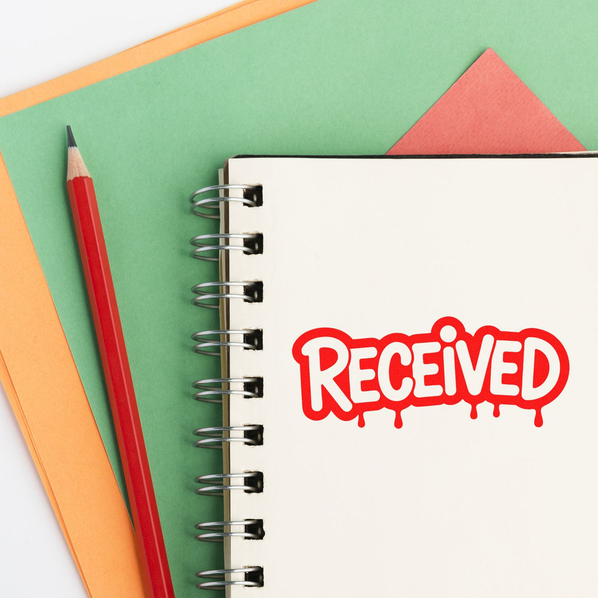Red RECEIVED rubber stamp on notebook page, ideal for office paperwork, document tracking, and approval labeling.