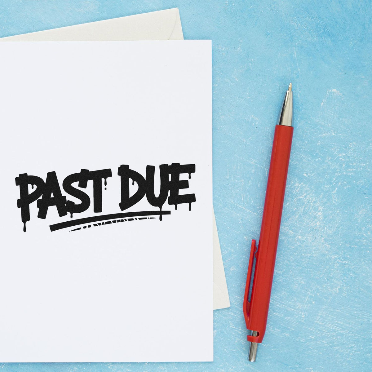 Past Due rubber stamp on white paper with red pen, perfect for overdue invoices and office mail processing.