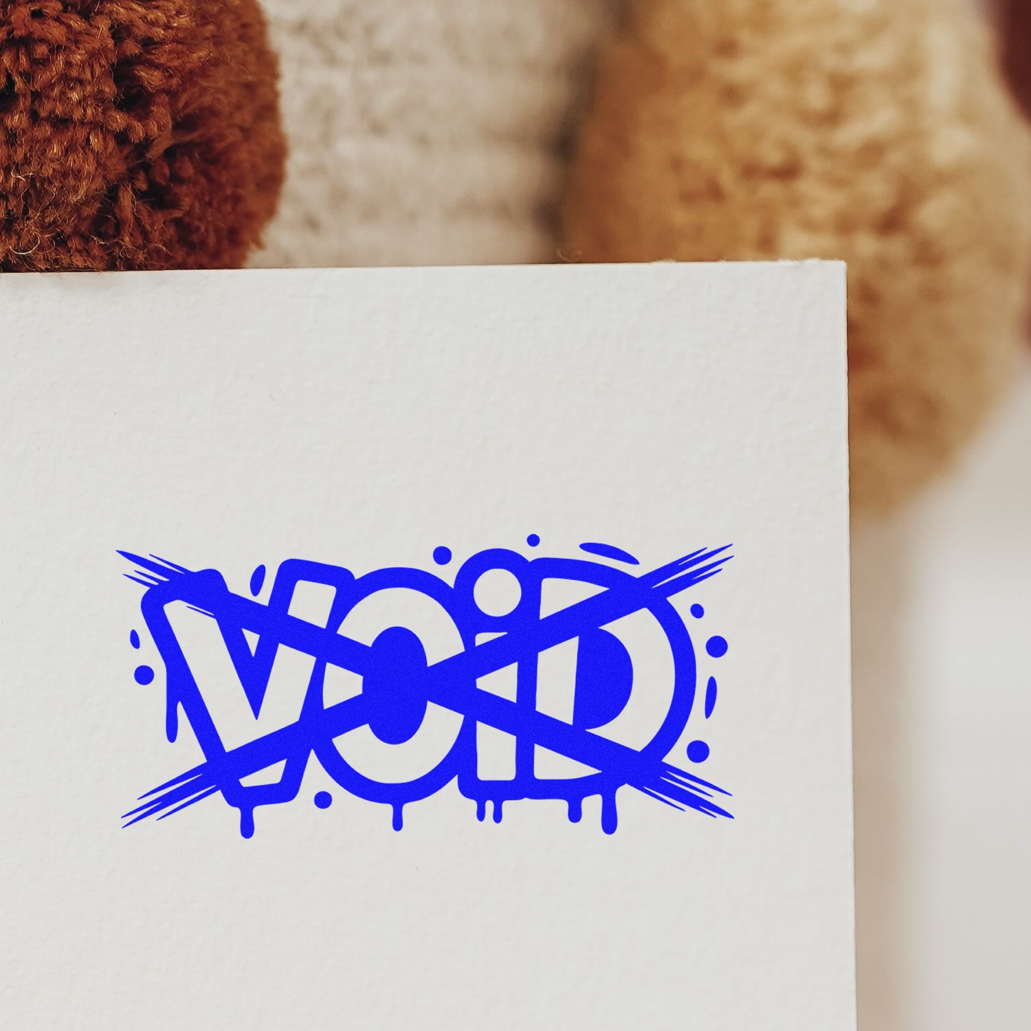 Blue VOID rubber stamp imprint on white paper for document cancellation and tamper-evident marking.