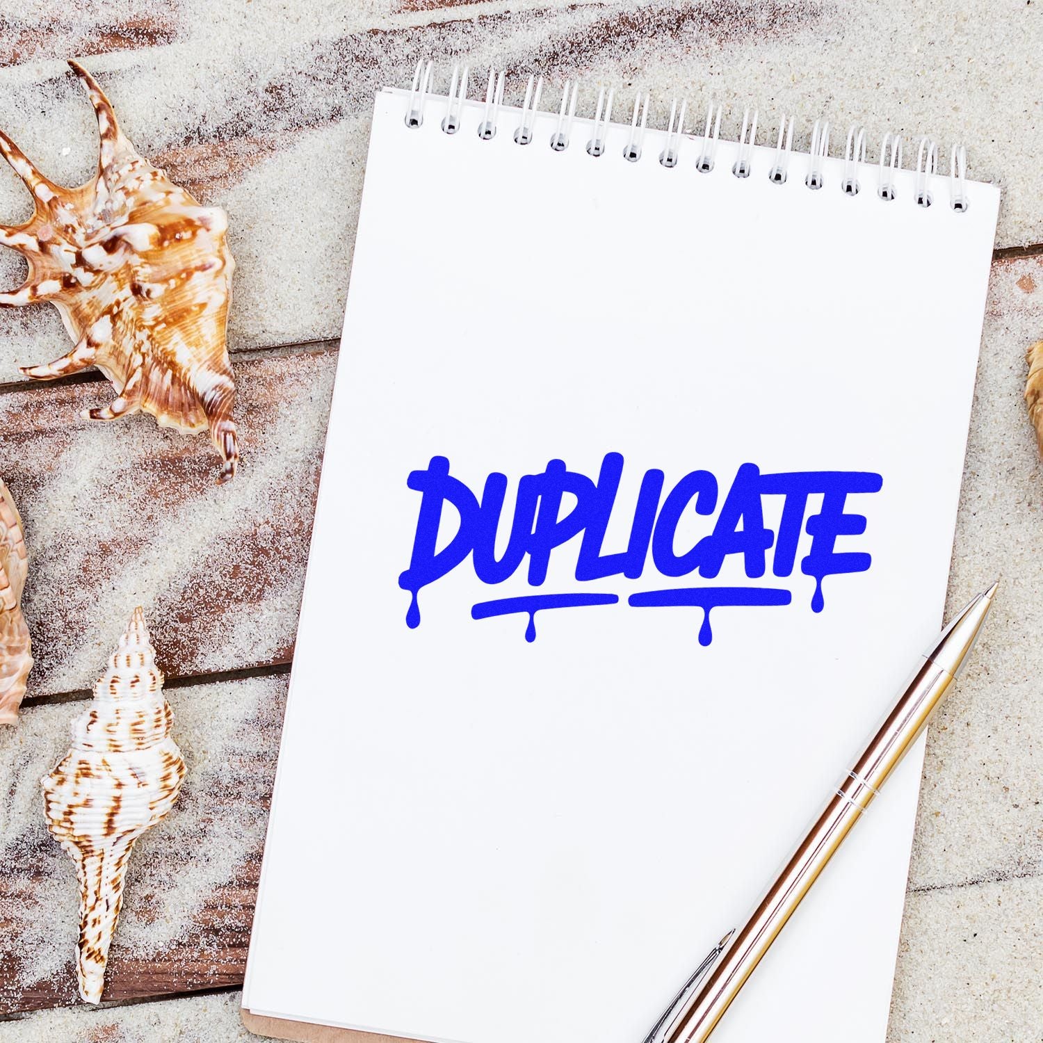 Blue duplicate rubber stamp graphic on a notebook, perfect for office paperwork and document copy marking.