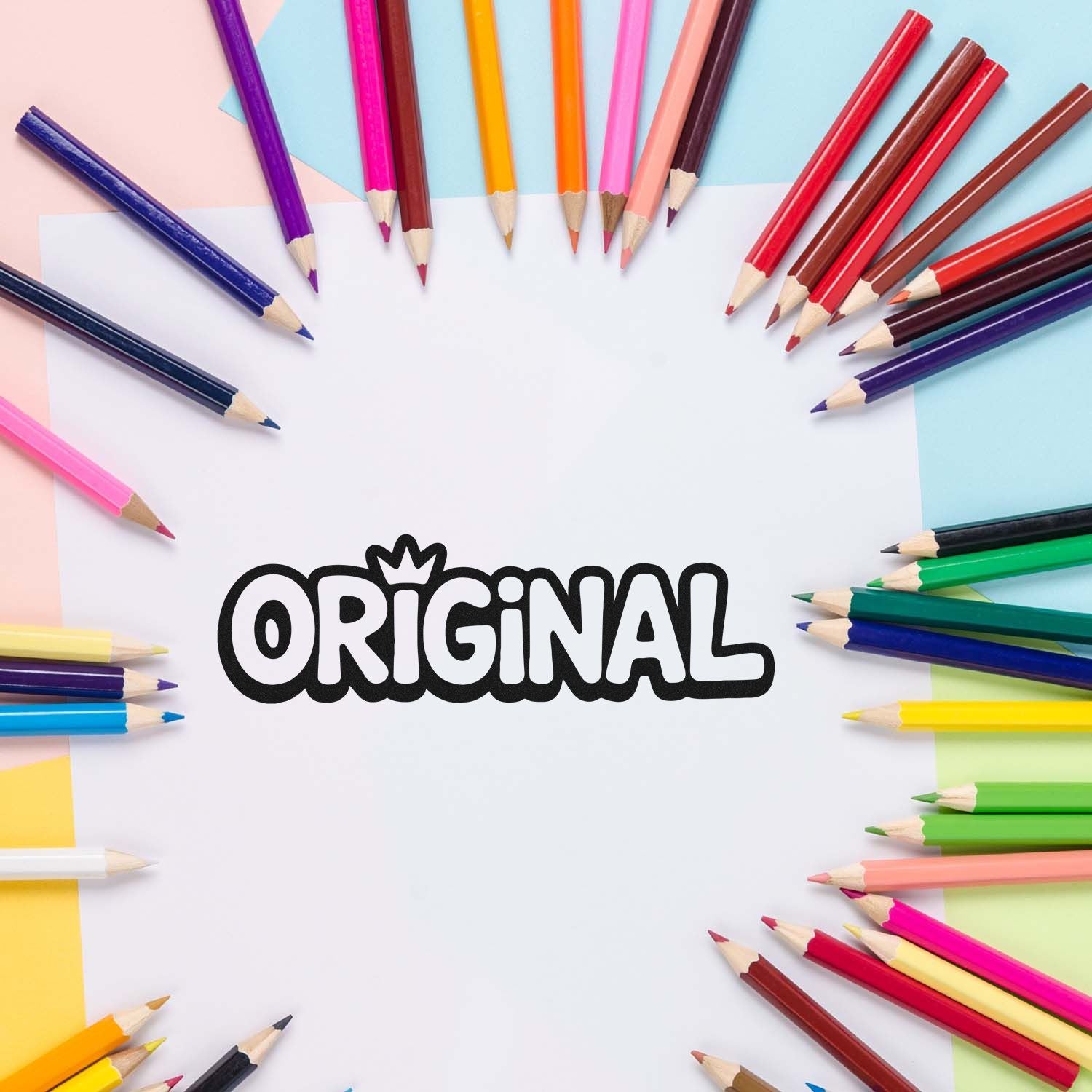 Original custom rubber stamp design on blank paper surrounded by colorful pencils, creative stationery concept.