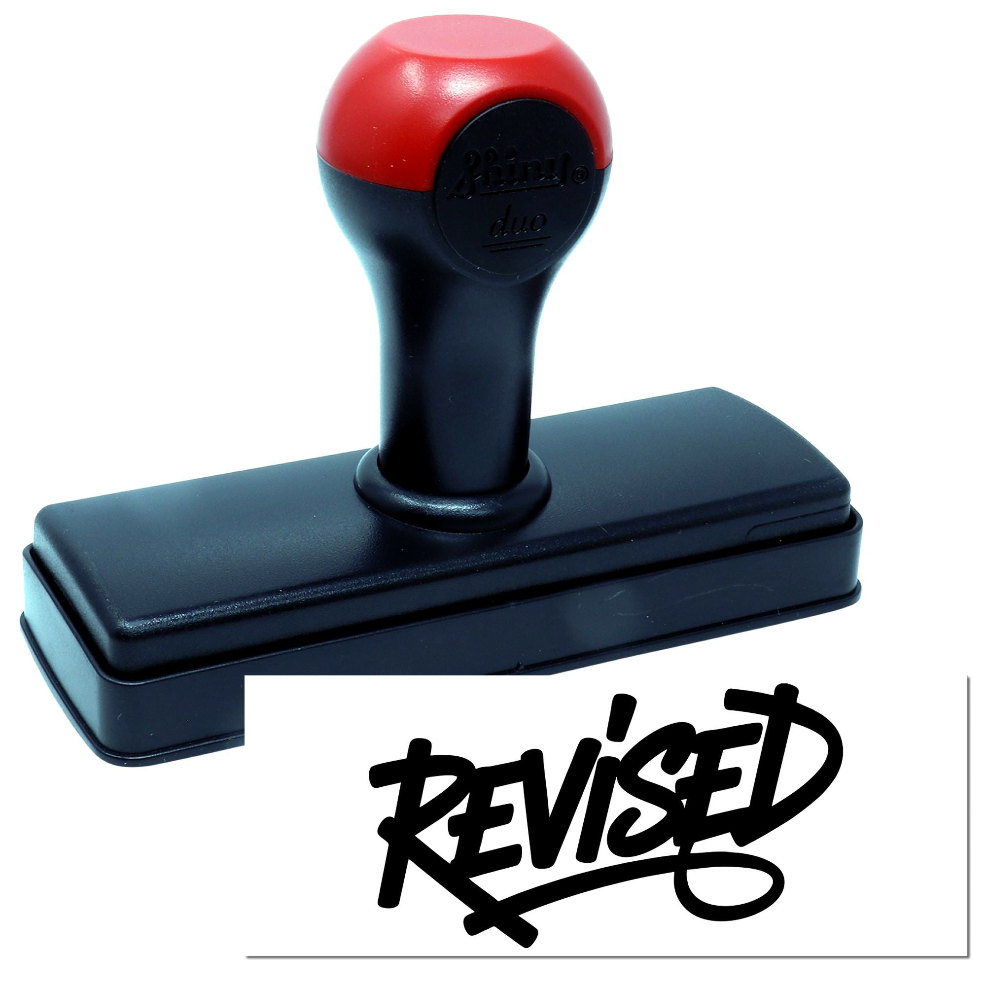 Self-inking revised rubber stamp with black and red handle, showing a bold Revised impression for office documents.