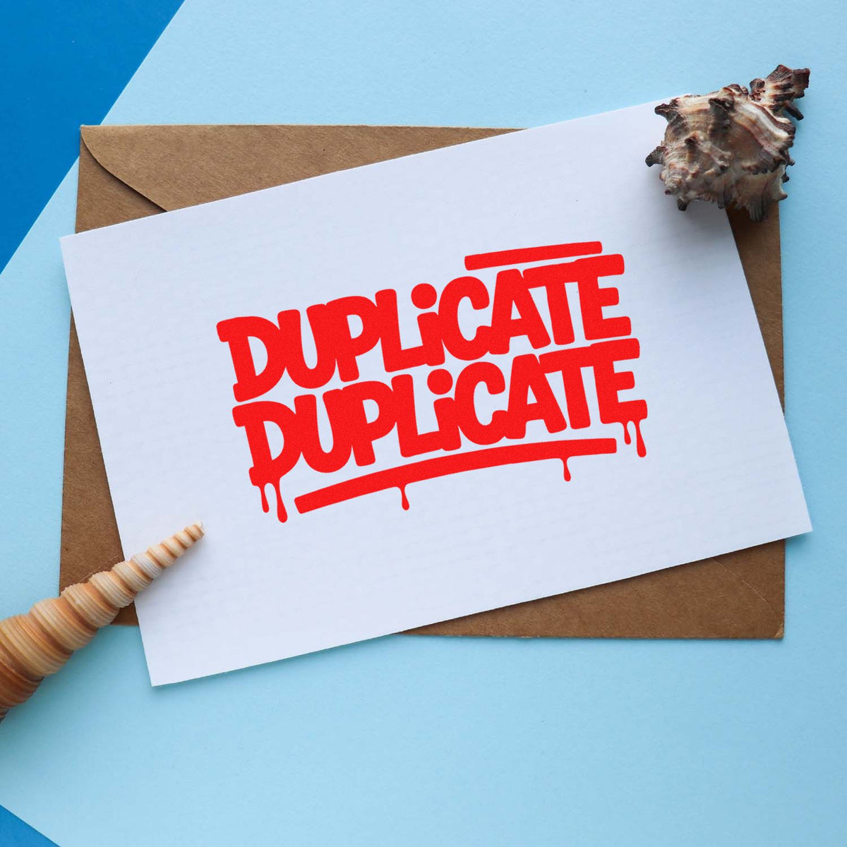 Red DUPLICATE rubber stamp on a card, ideal for office document control, mail sorting, and record keeping.