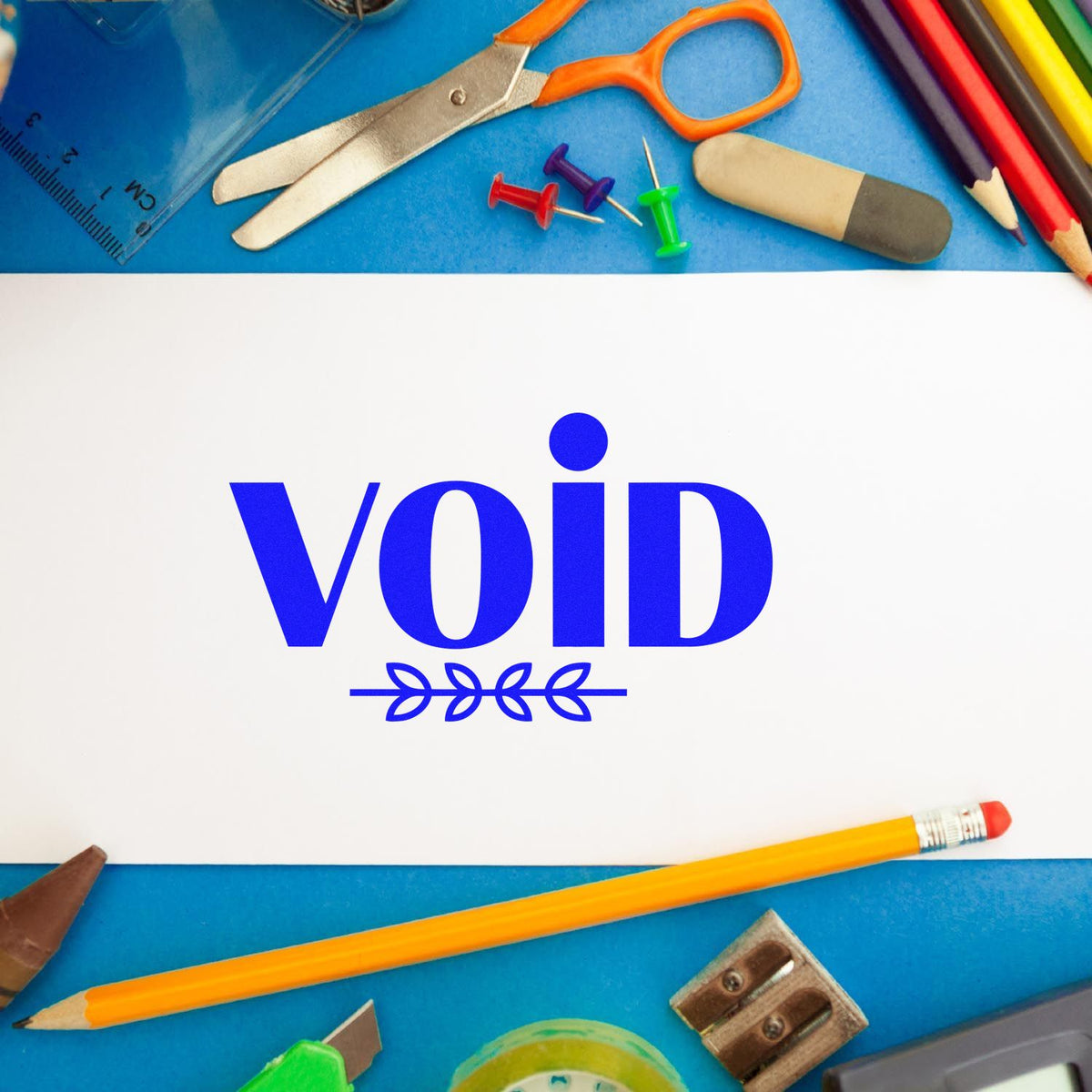 VOID rubber stamp on paper with school supplies, ideal for document marking and office use.