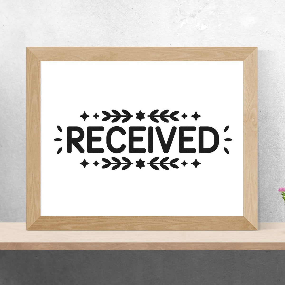 Decorative RECEIVED rubber stamp design with floral accents for mail, packaging, and office processing.