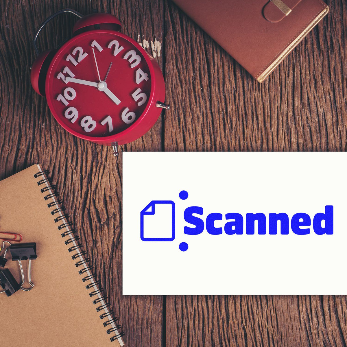 Scanned rubber stamp on office desk with clock, notebook, and clipboard for document processing.