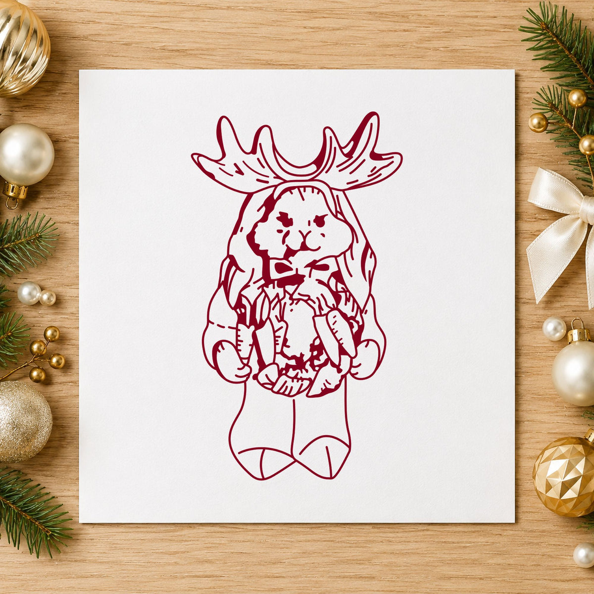 Bunny in Reindeer Costume Rubber Stamp impression in burgundy ink on white paper in a styled craft setting.