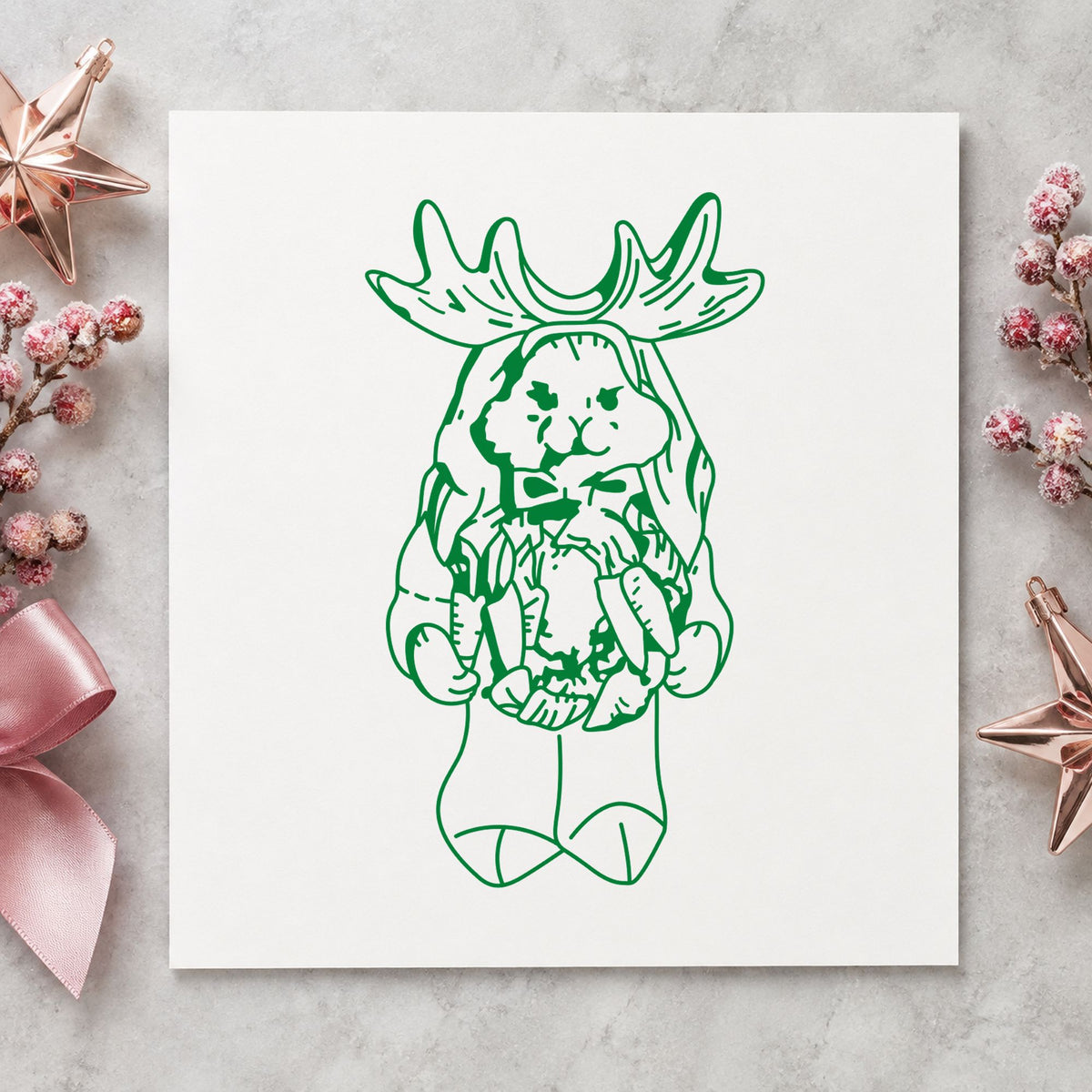 Bunny in Reindeer Costume Rubber Stamp impression in green ink on white paper in a styled craft setting.