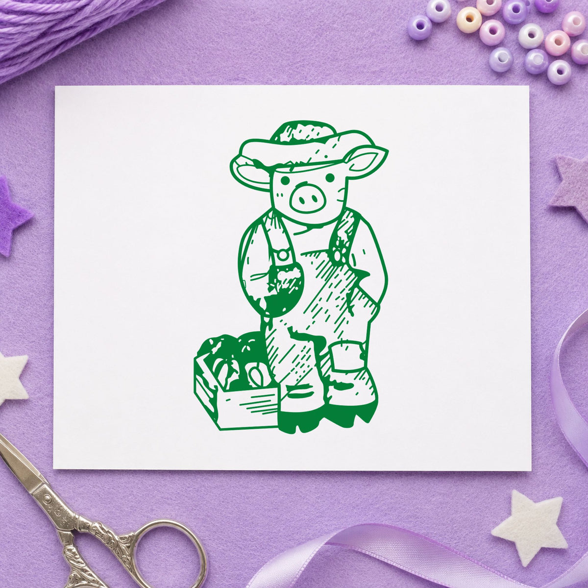 Farmer Pig with Produce Rubber Stamp impression in green ink on white paper in a styled craft setting.