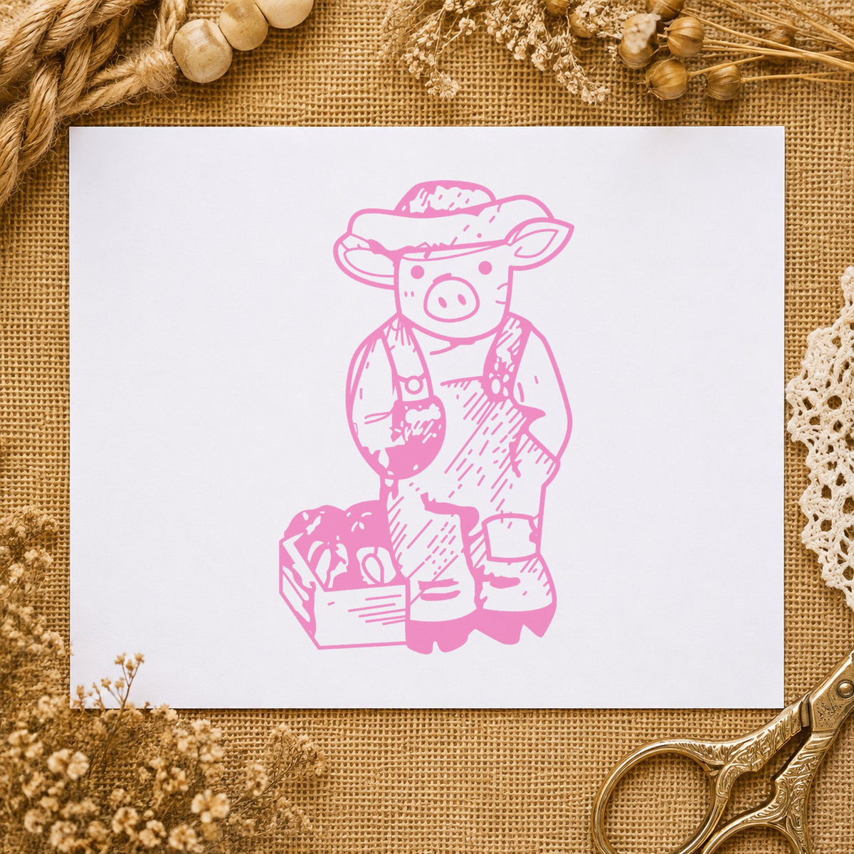 Farmer Pig with Produce Rubber Stamp impression in pink ink on white paper in a styled craft setting.