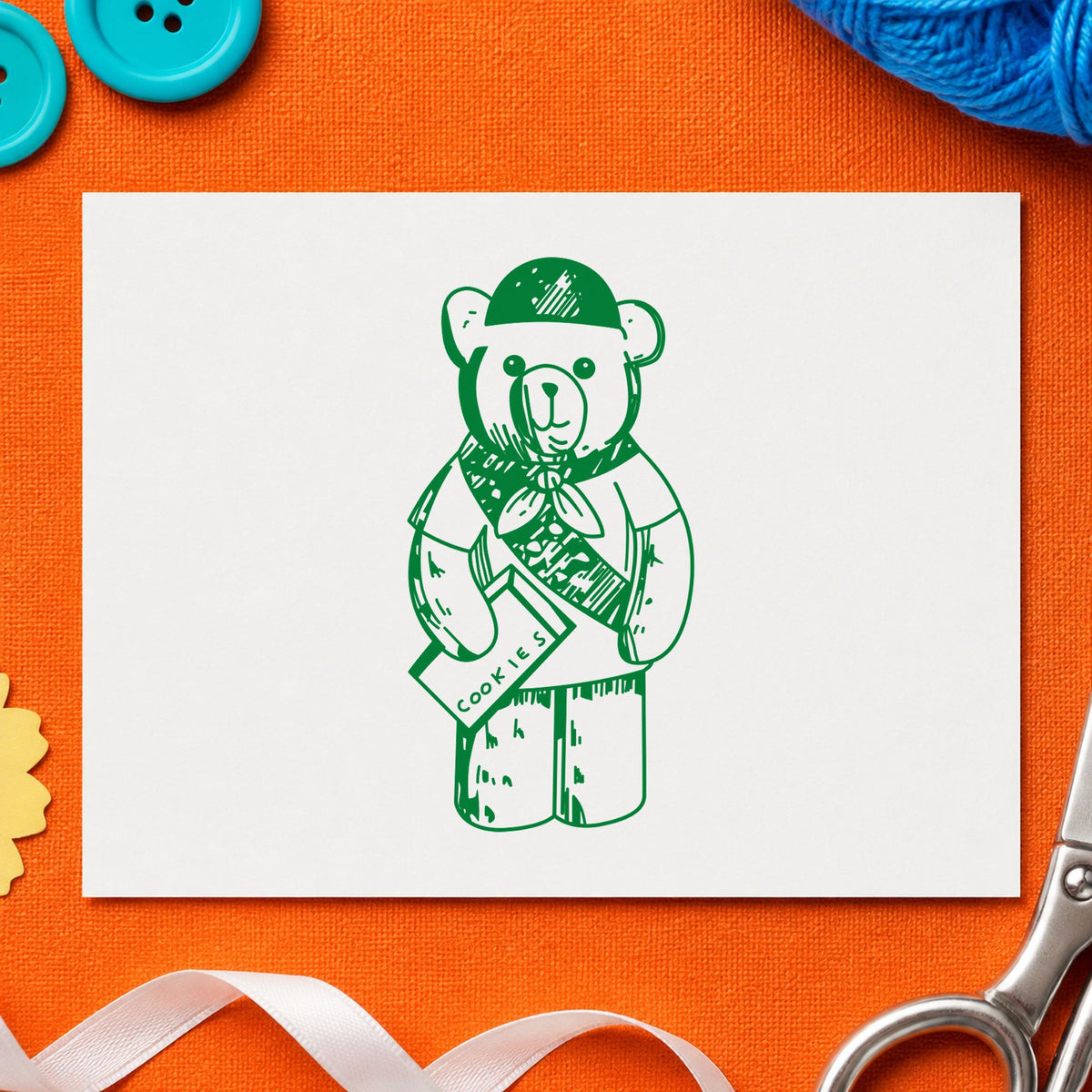 Scout Bear Rubber Stamp impression in green ink on white paper in a styled craft setting.