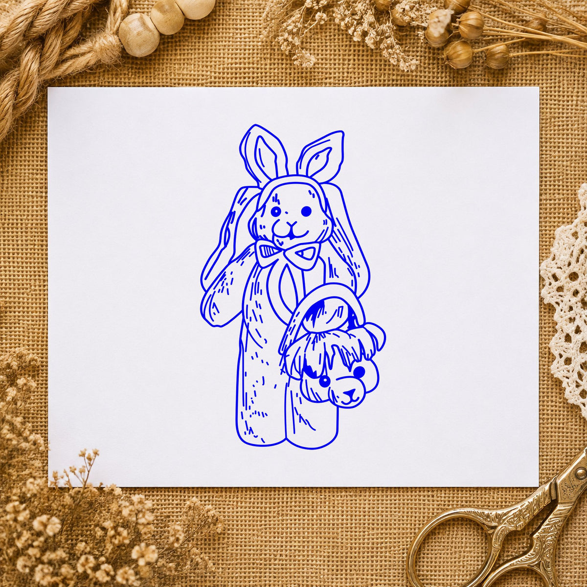 Blue rabbit craft stamp impression featuring the bunny with bear shaped basket design on white paper.