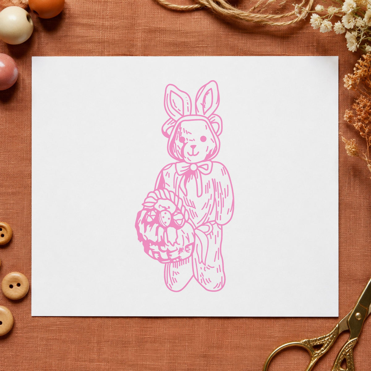 Bear in Bunny Costume with Basket Rubber Stamp impression in pink ink on white paper in a styled craft setting.
