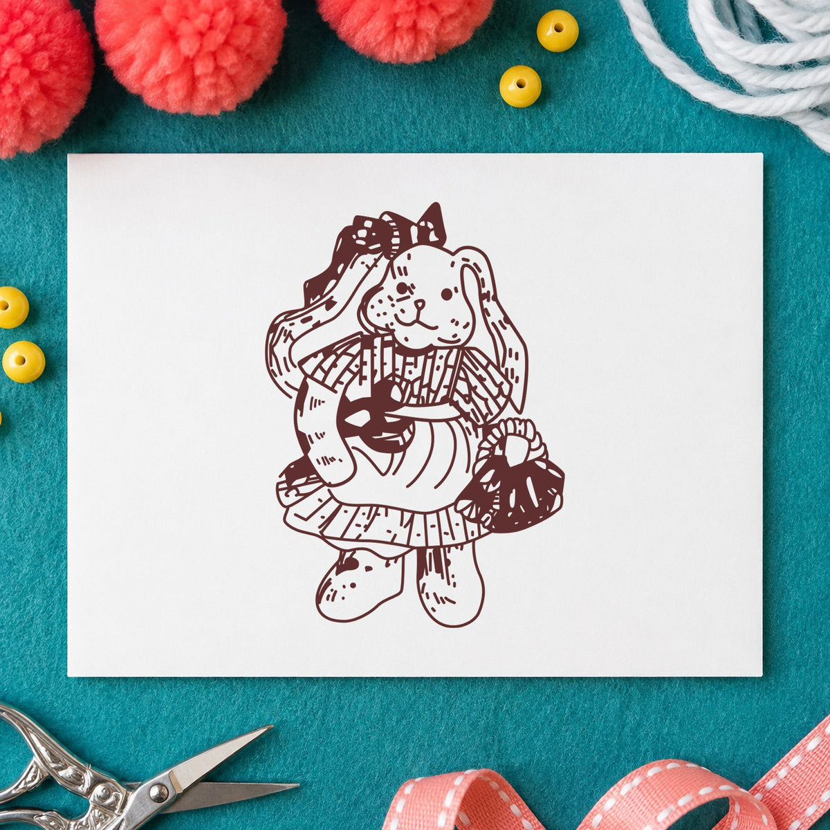 Country Bunny with Basket Rubber Stamp impression in brown ink on white paper in a styled craft setting.