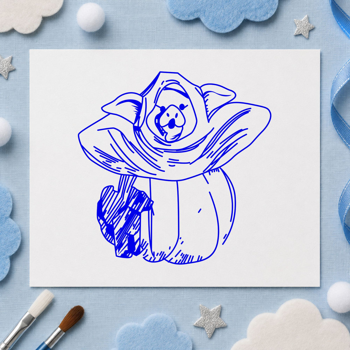 Blue pumpkin costume stamp impression featuring the pumpkin costume pig and black cat design on white paper.