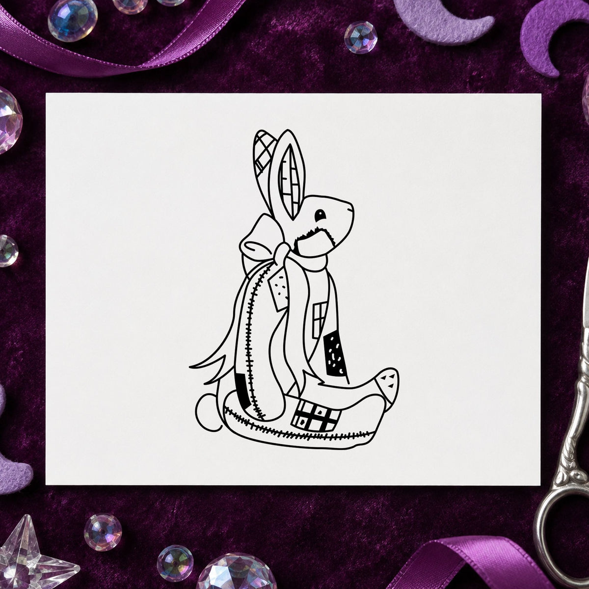 Patchwork Bunny with Bow Rubber Stamp impression in black ink on white paper in a styled craft setting.
