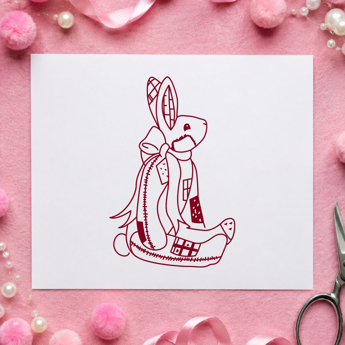 Patchwork Bunny with Bow Rubber Stamp impression in burgundy ink on white paper in a styled craft setting.