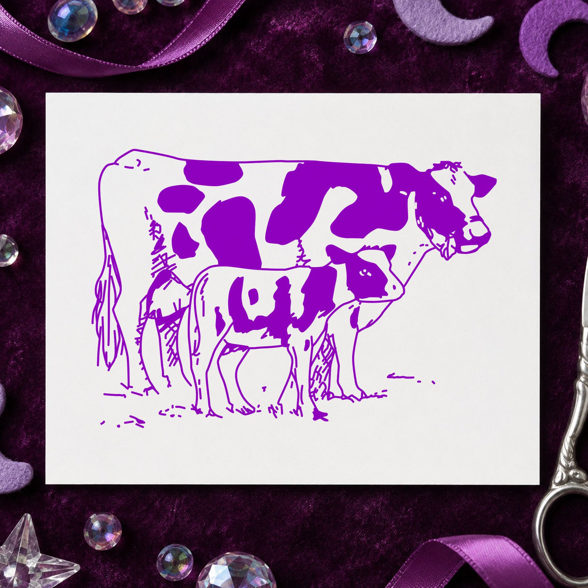 Mother Cow and Calf Rubber Stamp impression in purple ink on white paper in a styled craft setting.