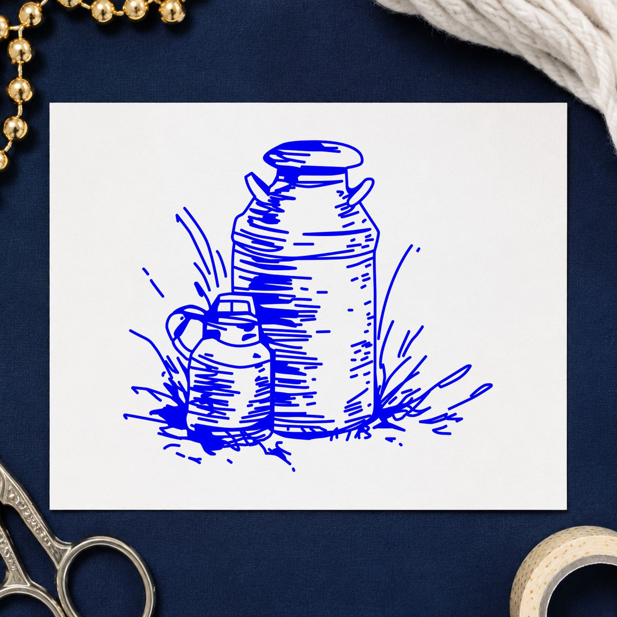 Blue farmhouse craft stamp impression featuring the two milk cans design on white paper.