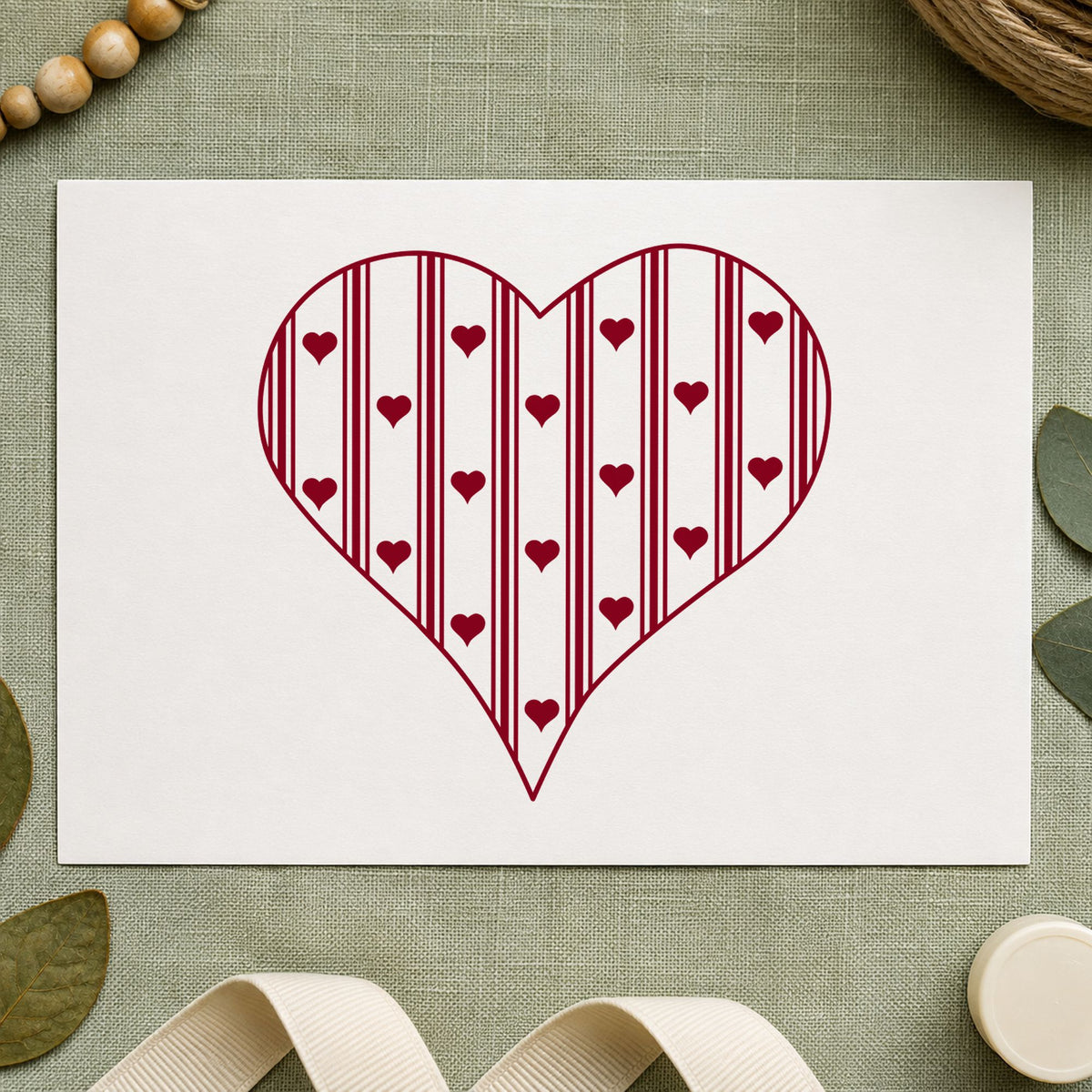 Striped Country Heart Rubber Stamp impression in burgundy ink on white paper in a styled craft setting.