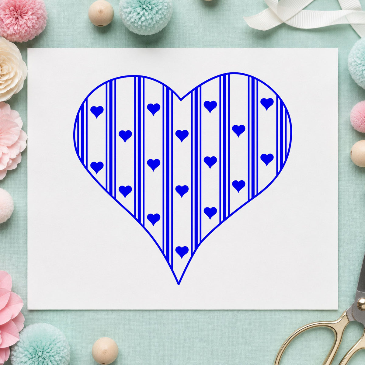 Striped Country Heart Rubber Stamp impression in blue ink on white paper in a styled craft setting.