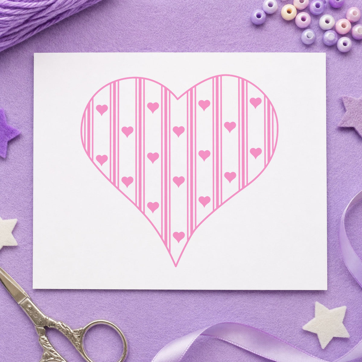 Striped Country Heart Rubber Stamp impression in pink ink on white paper in a styled craft setting.