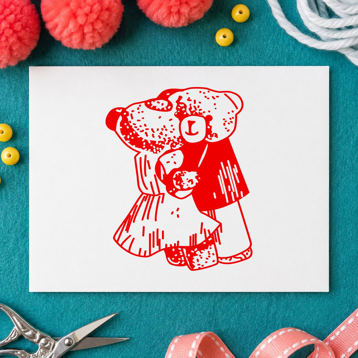 Dancing Teddy Bear Couple Rubber Stamp impression in red ink on white paper in a styled craft setting.