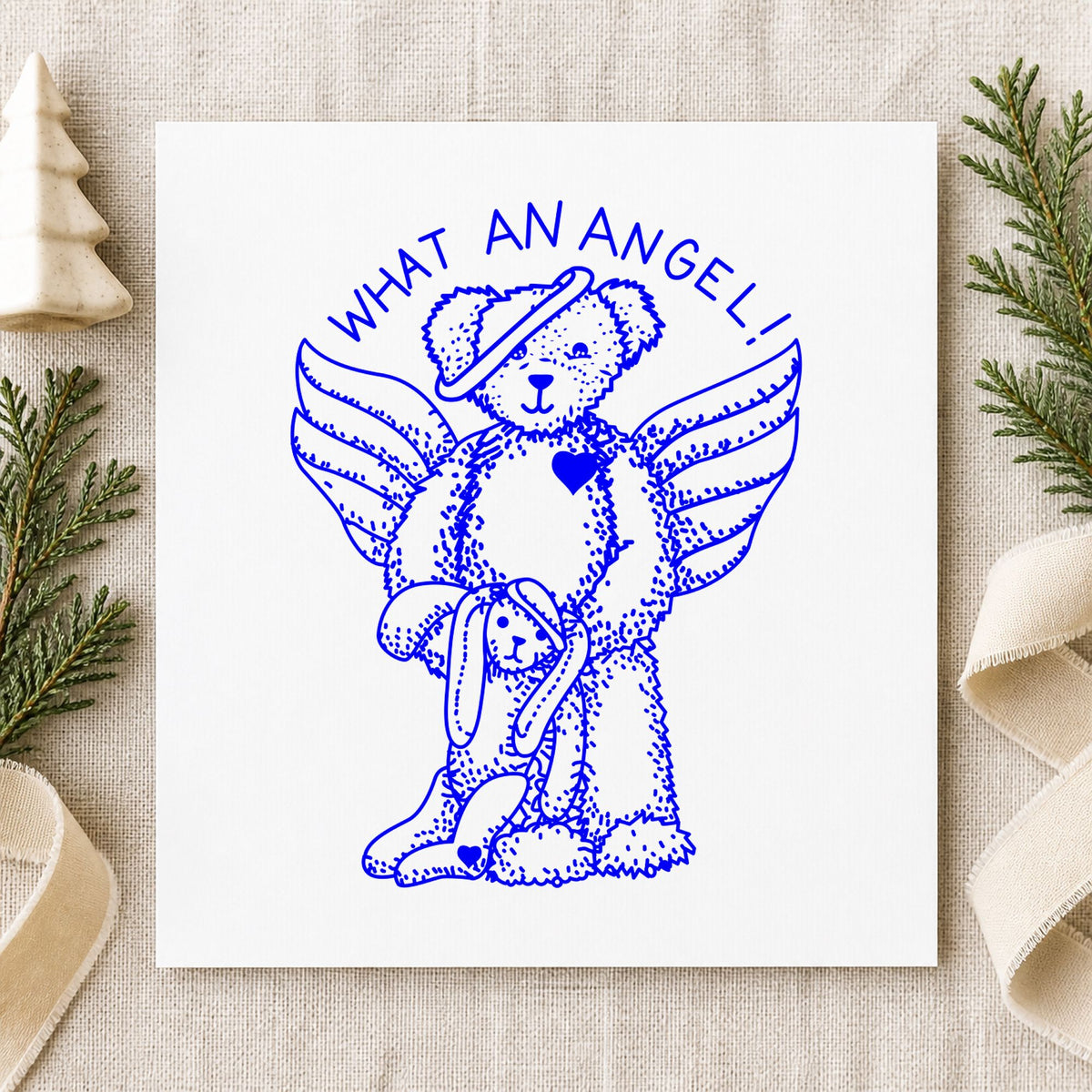 Blue teddy bear craft stamp impression featuring the what an angel bear and bunny design on white paper.