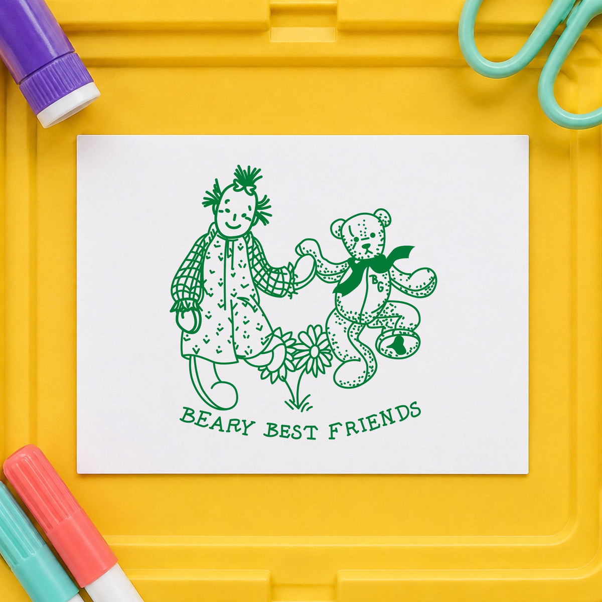 Beary Best Friends Bear and Doll Rubber Stamp impression in green ink on white paper in a styled craft setting.