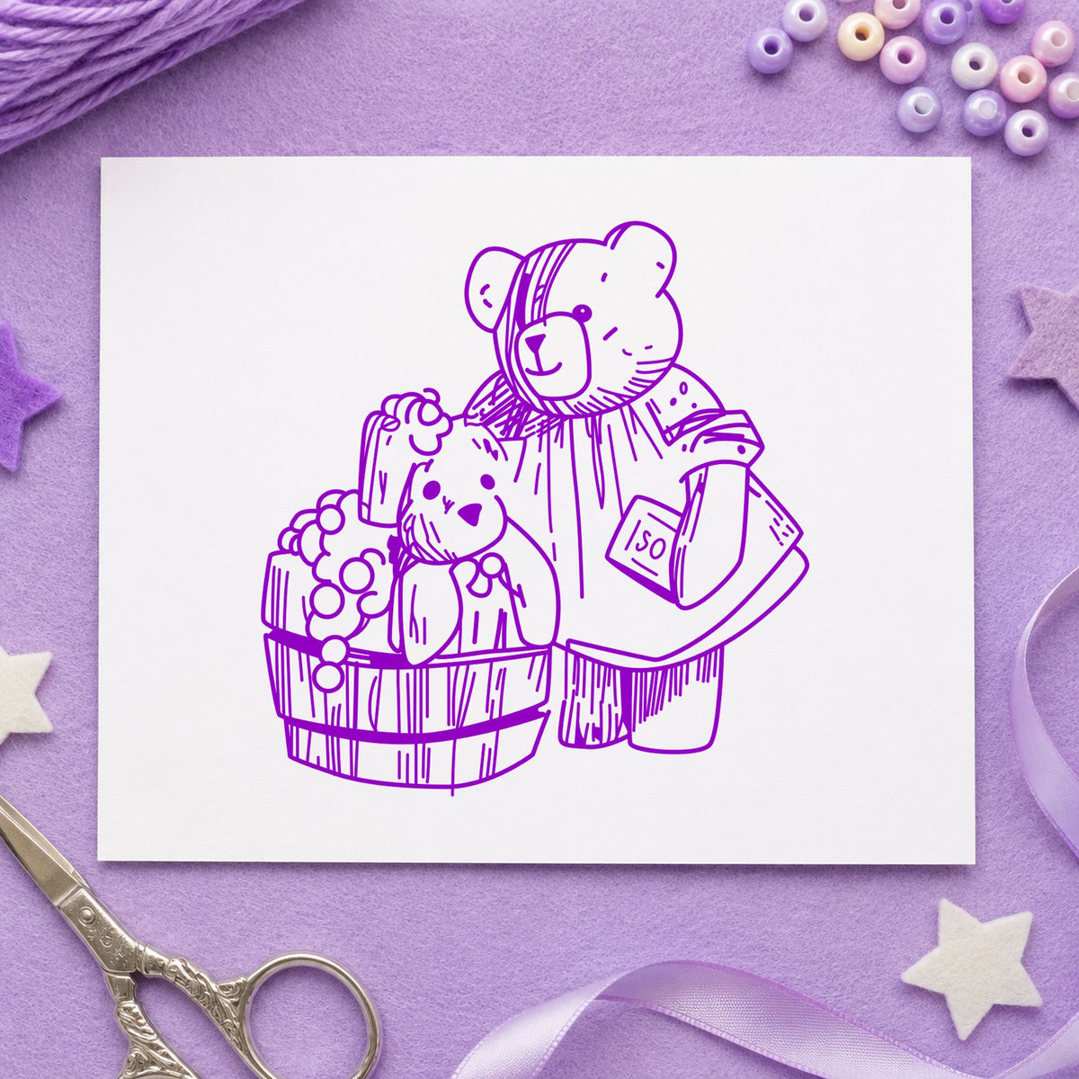 Bear Washing Teddy in Barrel Rubber Stamp impression in purple ink on white paper in a styled craft setting.