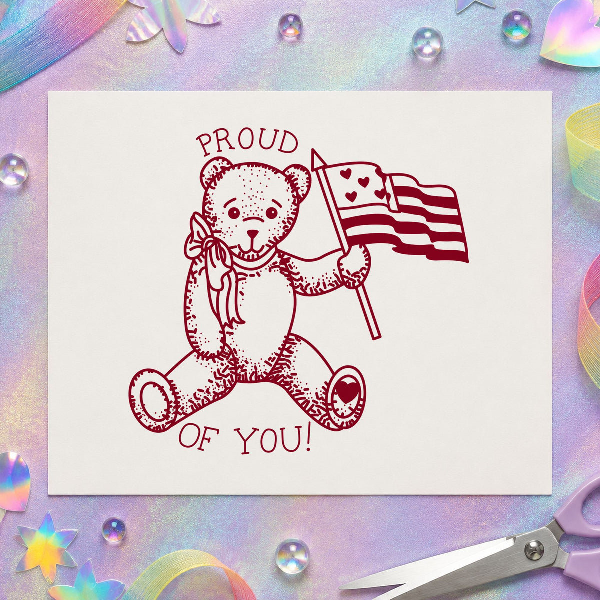Proud of You Flag Bear Rubber Stamp Small impression in burgundy ink on white paper in a styled craft setting.