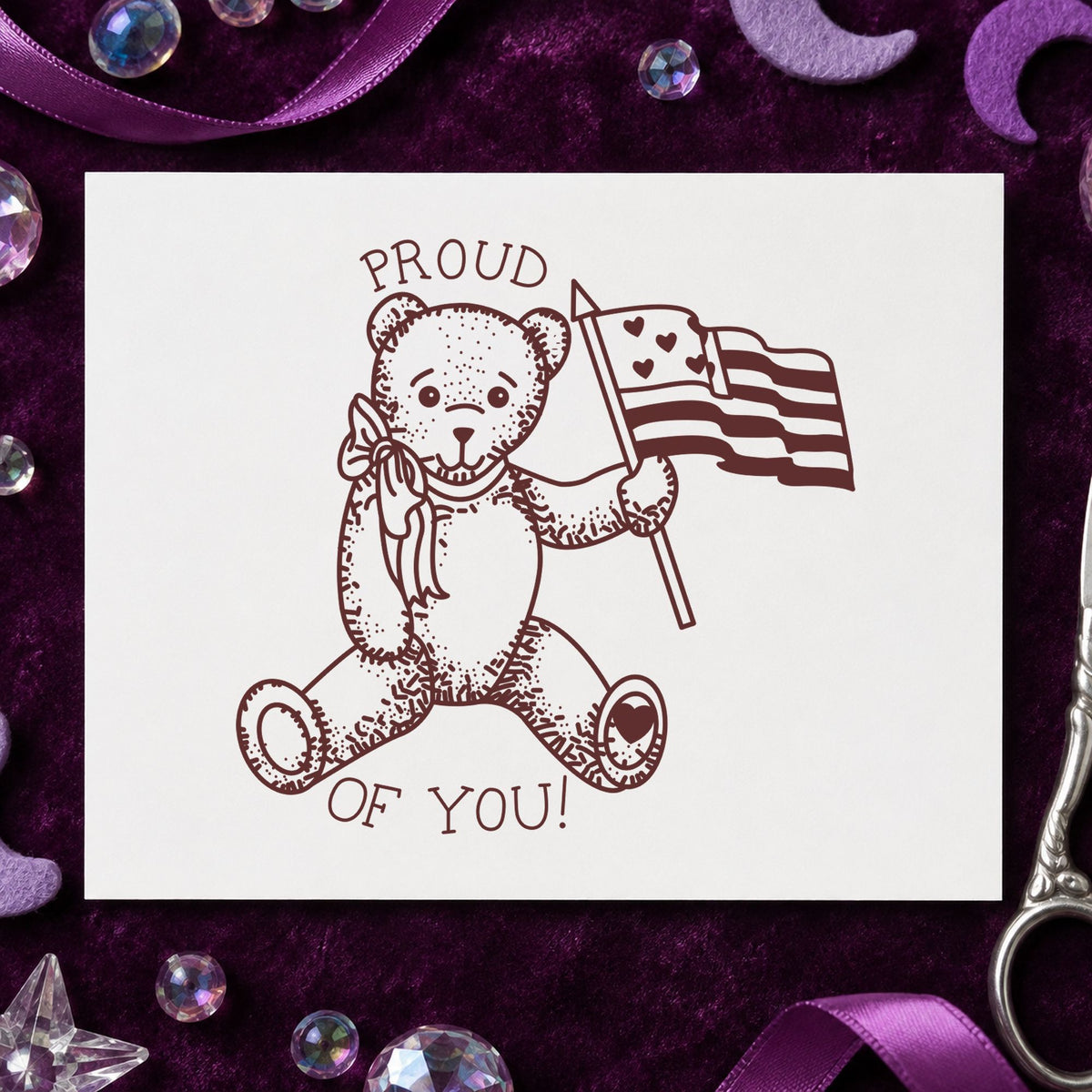 Proud of You Flag Bear Rubber Stamp Small impression in brown ink on white paper in a styled craft setting.