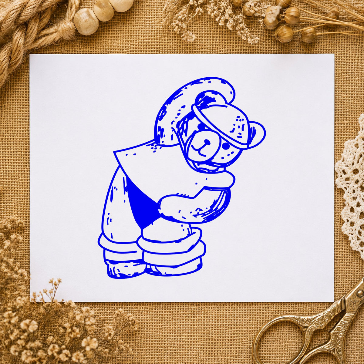 Blue fitness craft stamp impression featuring the workout bear in headband design on white paper.