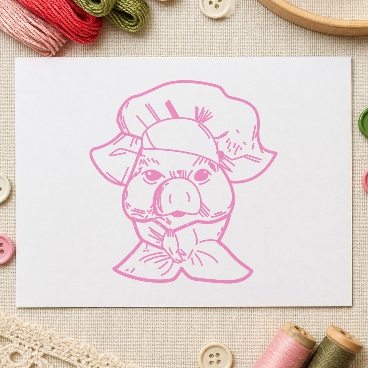 Chef Pig Portrait Rubber Stamp impression in pink ink on white paper in a styled craft setting.