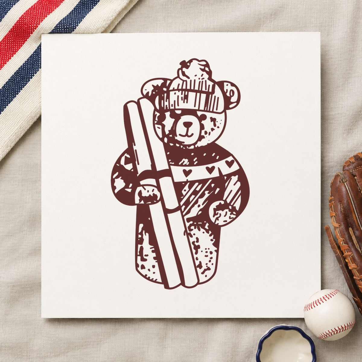 Ski Bear Holding Skis Rubber Stamp impression in brown ink on white paper in a styled craft setting.