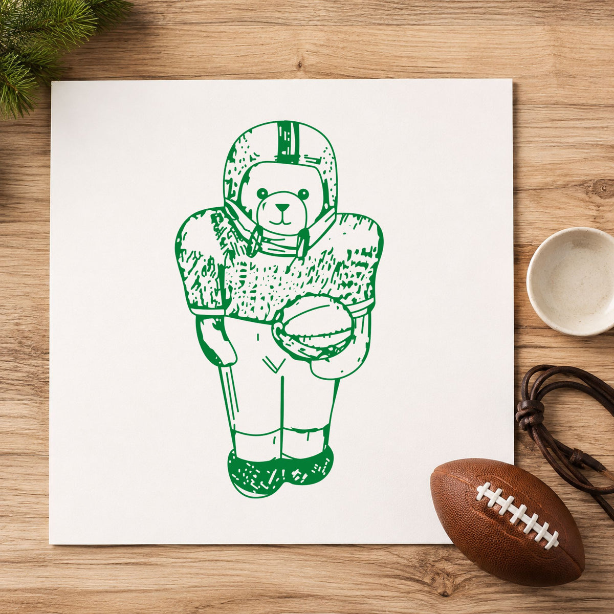 Football Bear in Uniform Rubber Stamp impression in green ink on white paper in a styled craft setting.