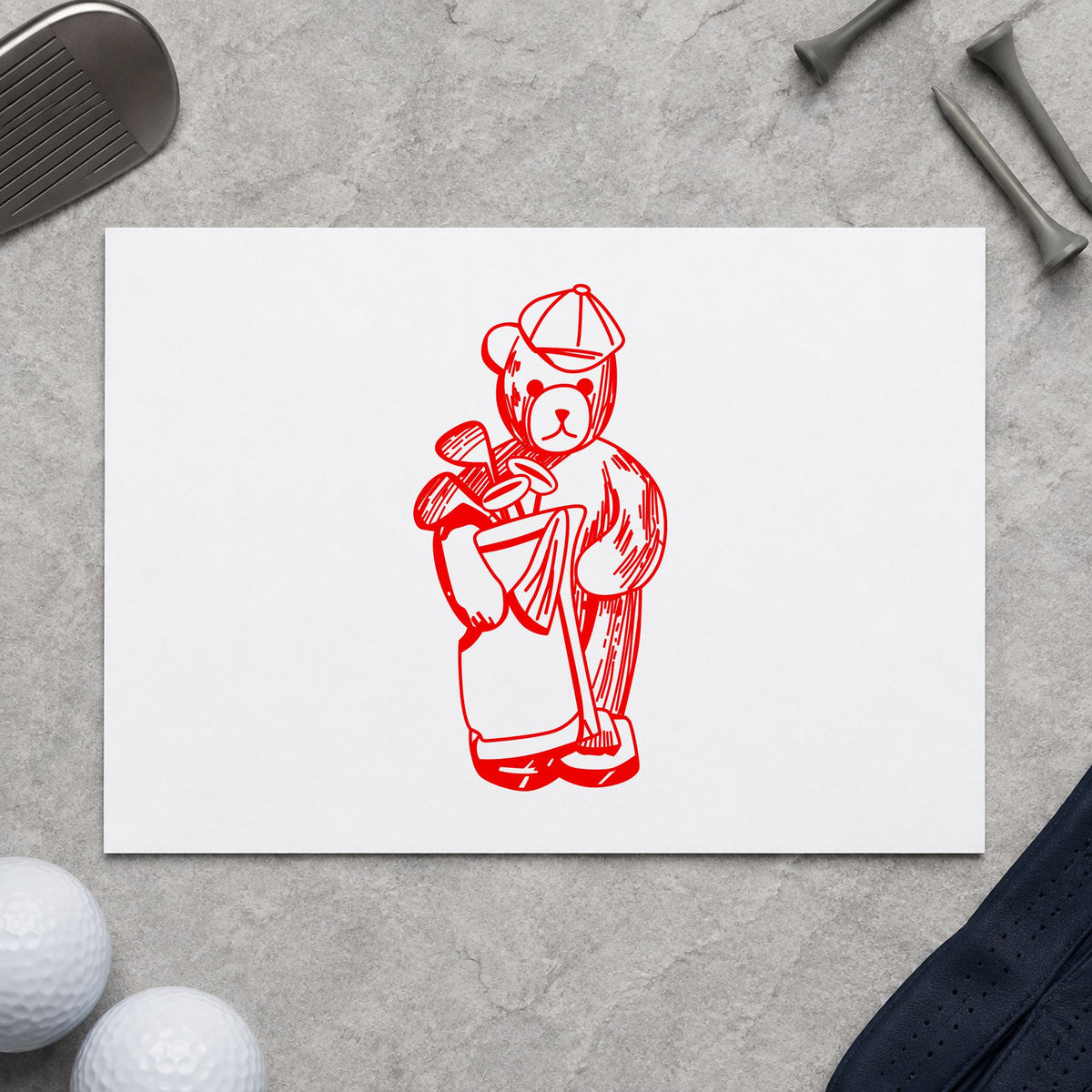 Golf Bear with Clubs Rubber Stamp impression in red ink on white paper in a styled craft setting.