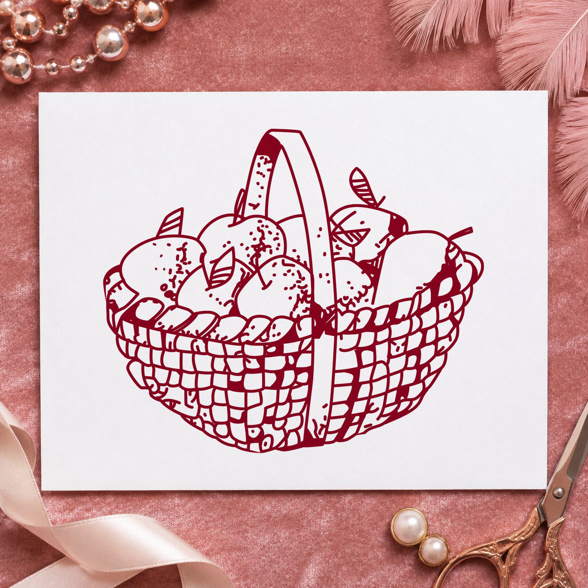 Round Apple Basket Rubber Stamp impression in burgundy ink on white paper in a styled craft setting.