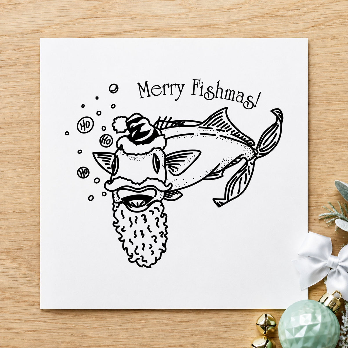 Black impression from a christmas fish stamp, featuring the merry fishmas catfish design on white paper.