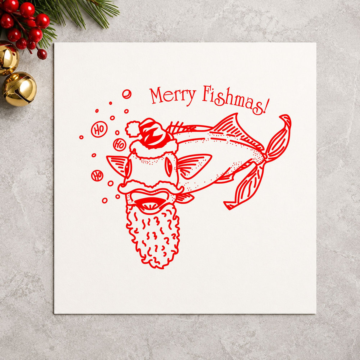 Merry Fishmas Catfish Rubber Stamp impression in red ink on white paper in a styled craft setting.