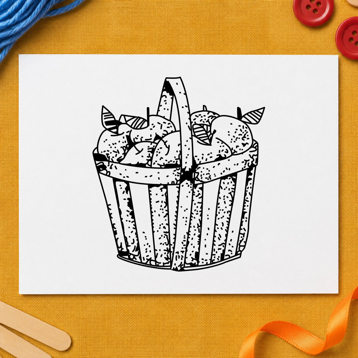 Slatted Apple Basket Rubber Stamp impression in black ink on white paper in a styled craft setting.